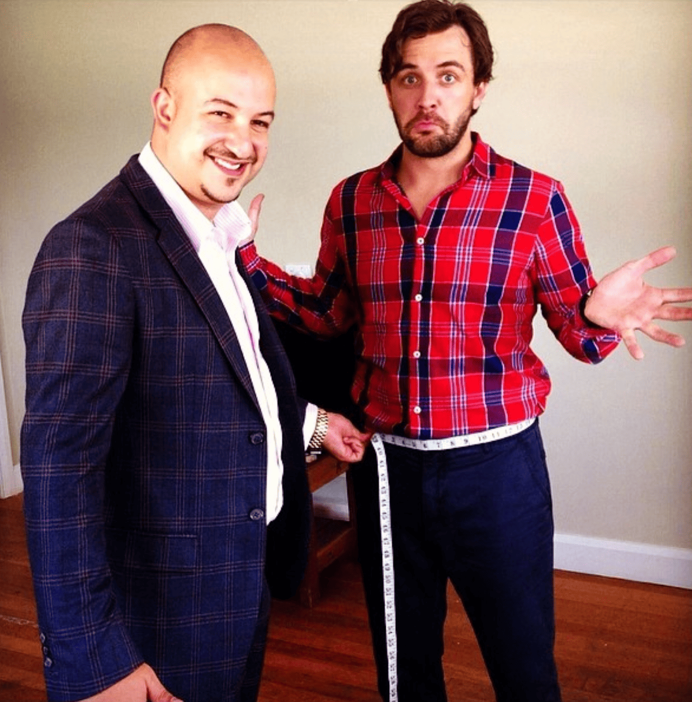 Master tailor taking measurements for a bespoke suit