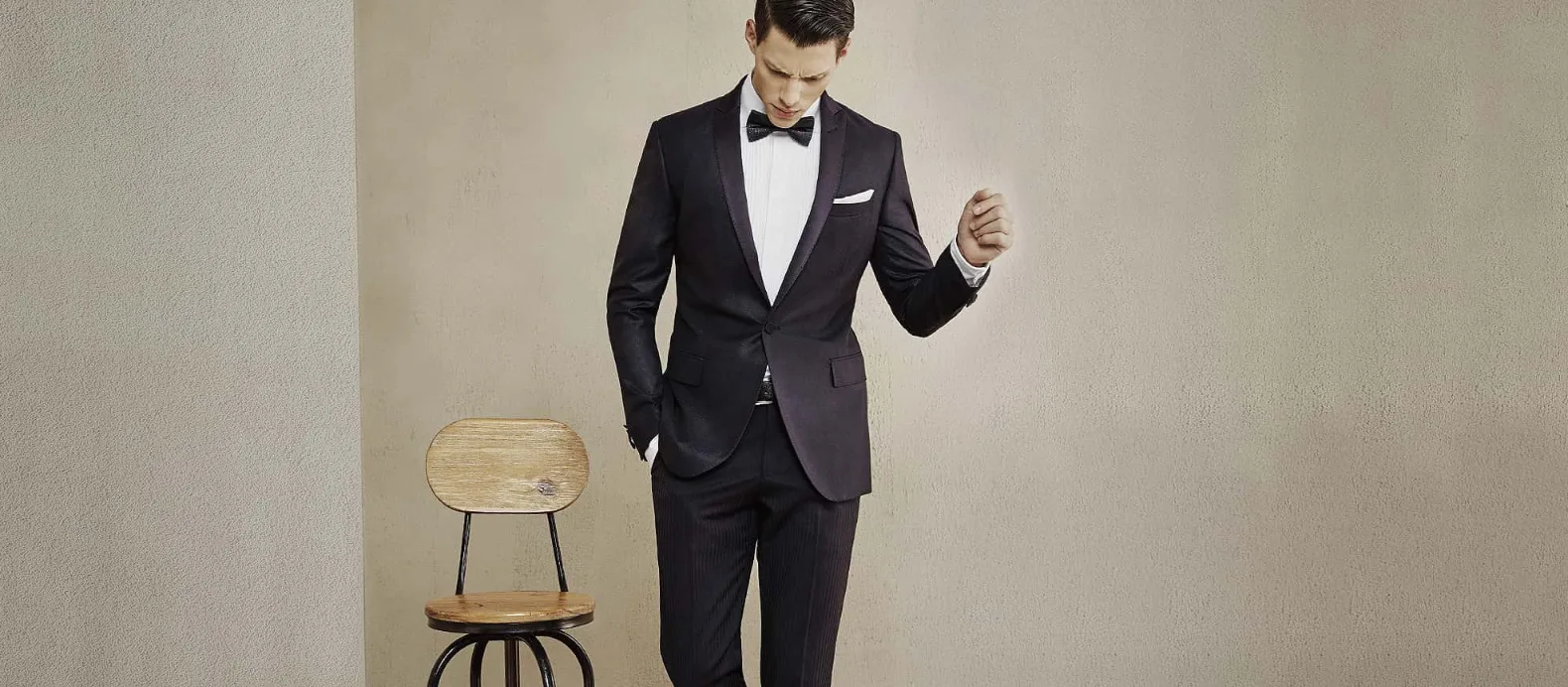 Perfectly fitted bespoke dinner suit showing balanced shoulders and trouser line